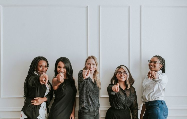 Business Women Pointing at Camera